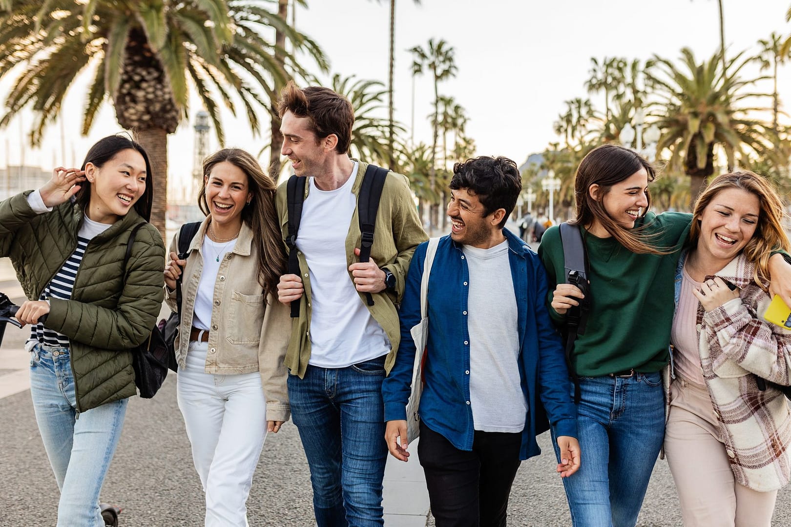 Friends walking along the Barcelona waterfront on a Western Europe group tour for 18-30s
