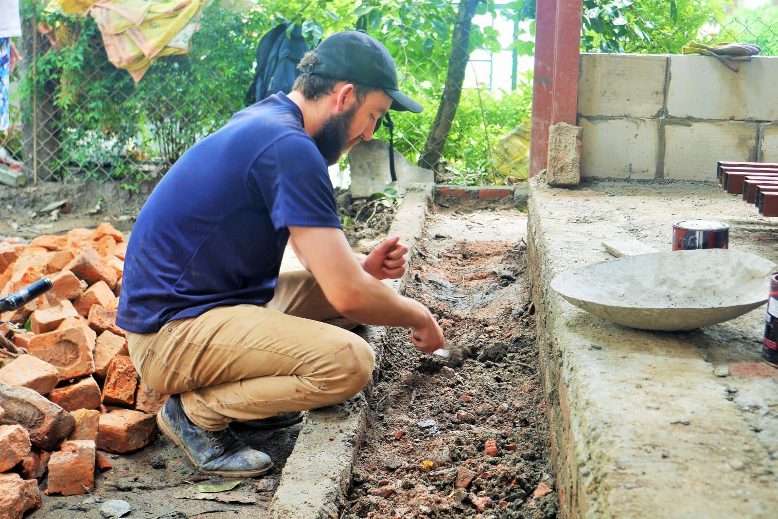 Volunteer laying bricks at a community building project in Nepal