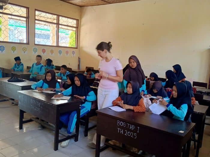 Volunteer teaching English in a classroom in Lombok, Indonesia